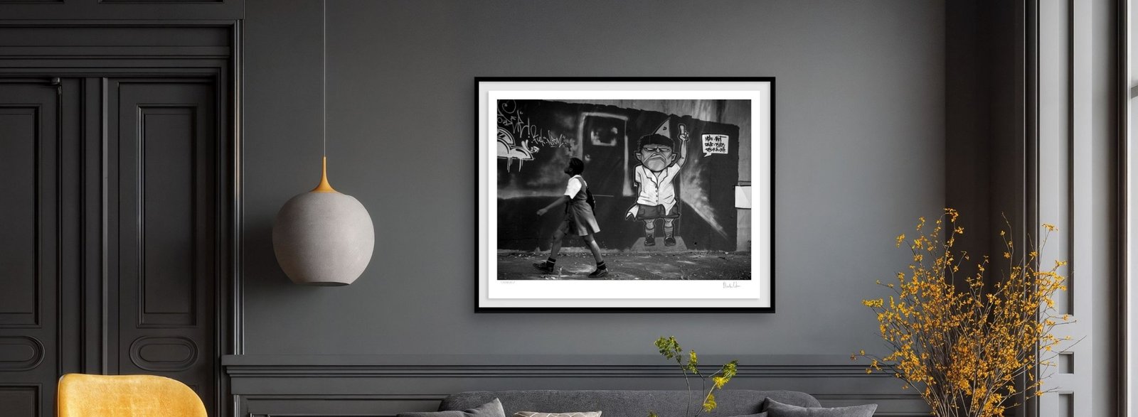 A framed black and white urban photograph by Martin Osner in a room