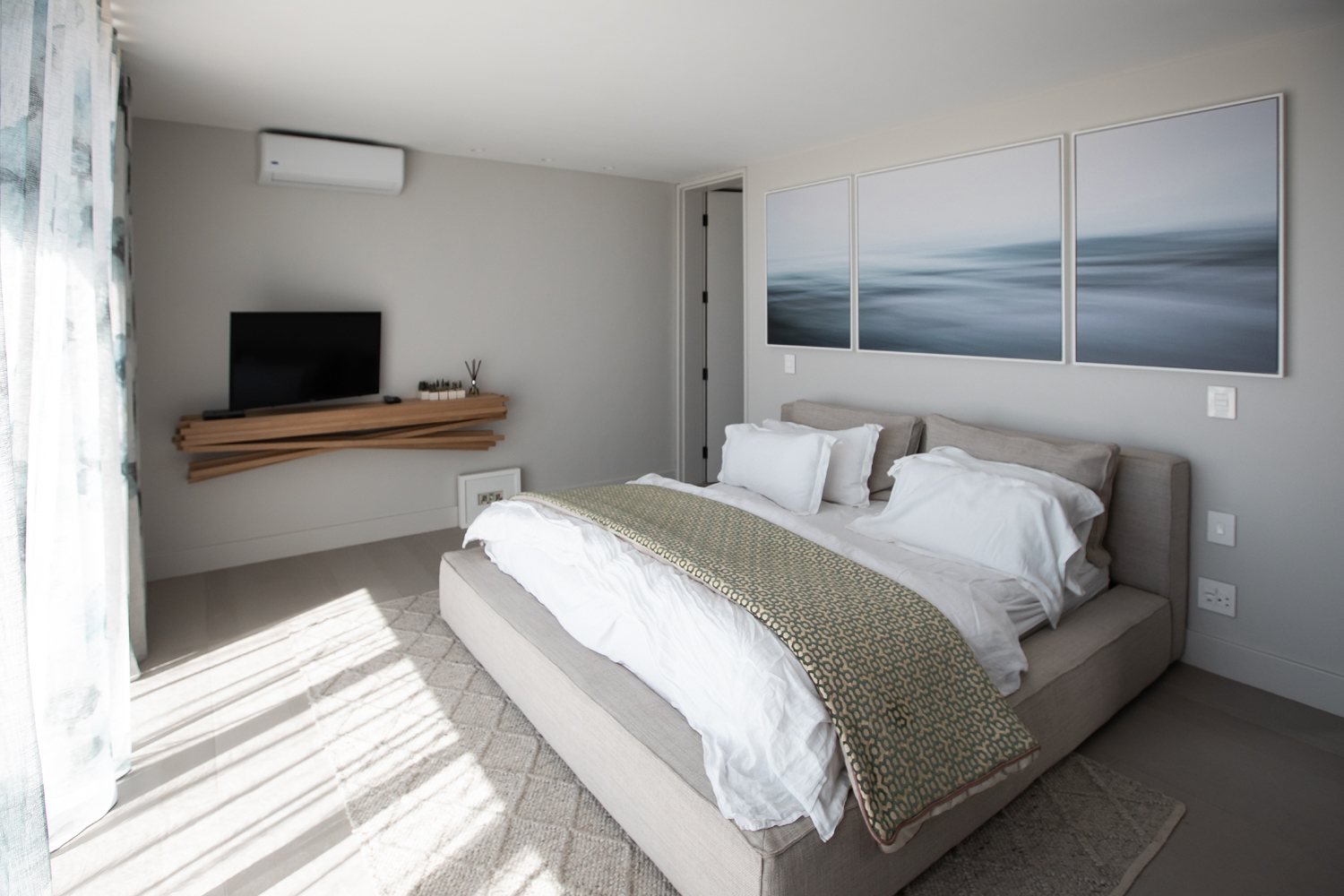 The finished bedroom with the three panel seascape hung above the bed
