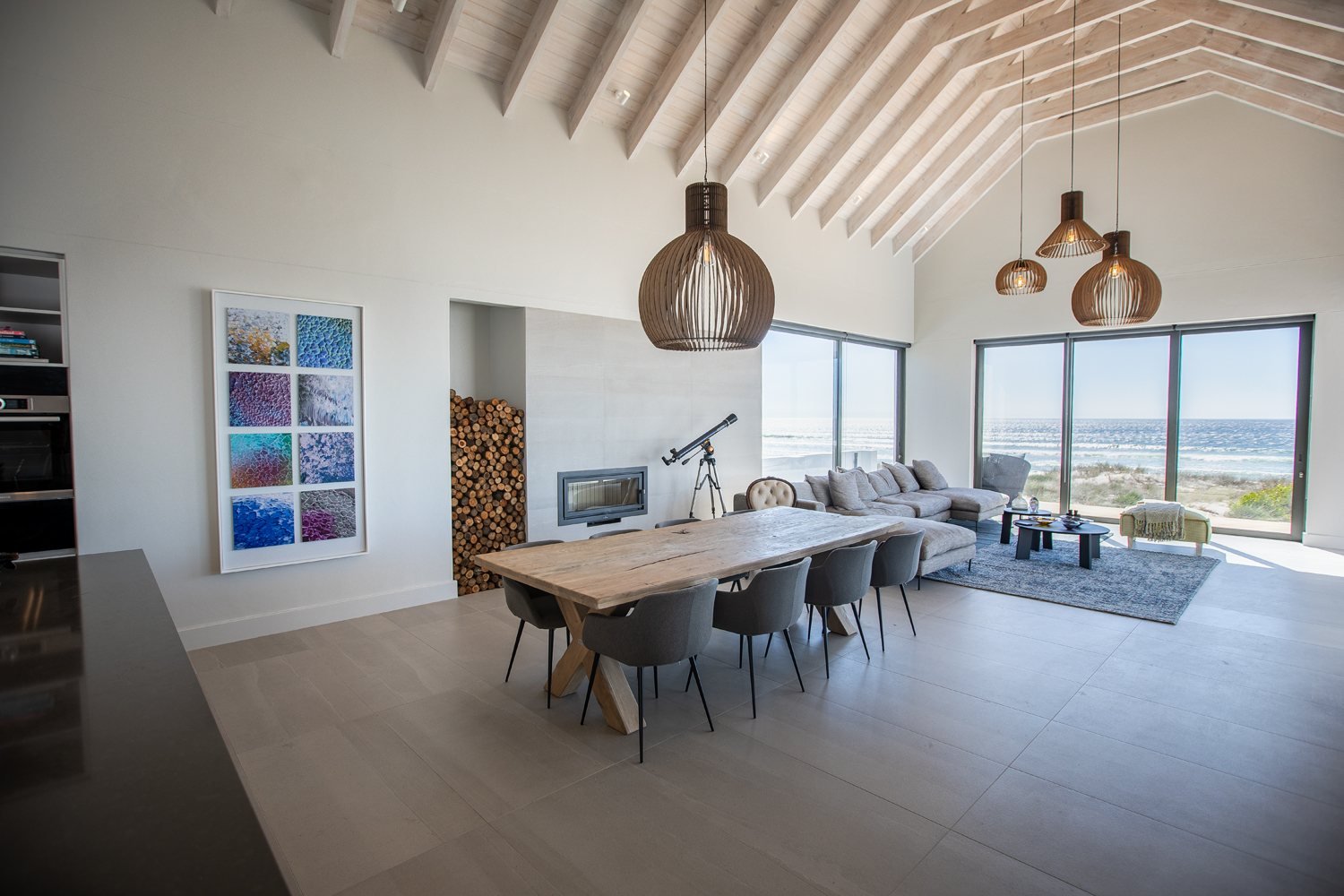 A home art consultant project: a large eight panel artwork in an open plan room with a sea view
