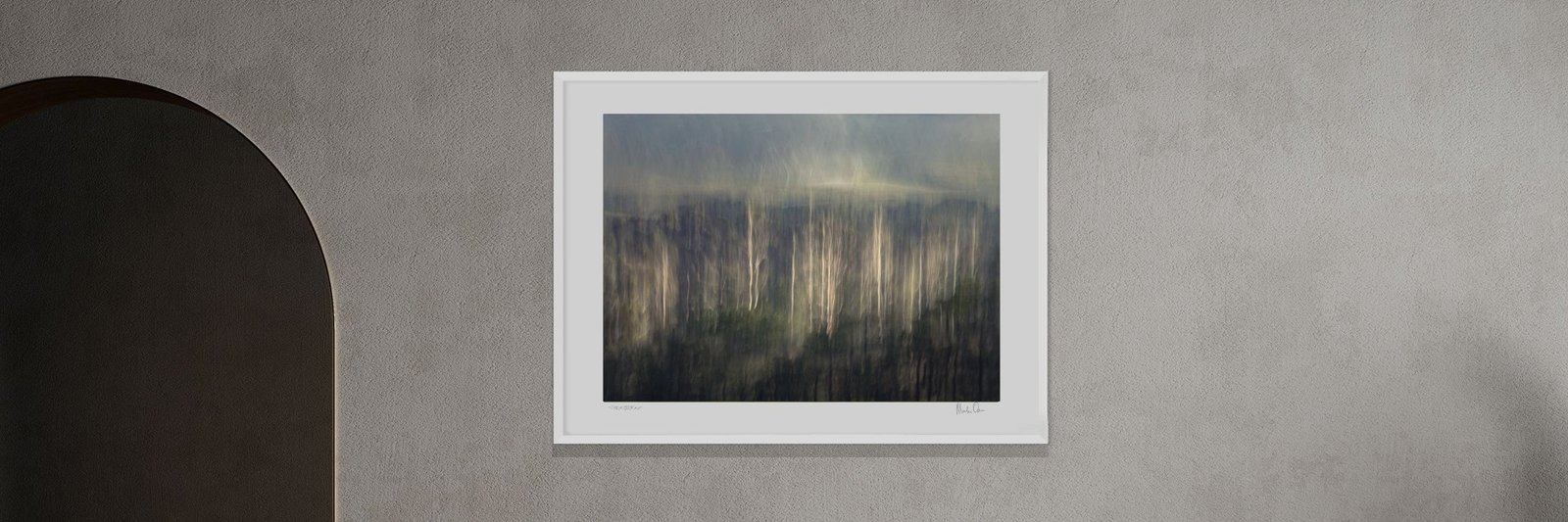A framed ethereal landscape photograph by Martin Osner in a room