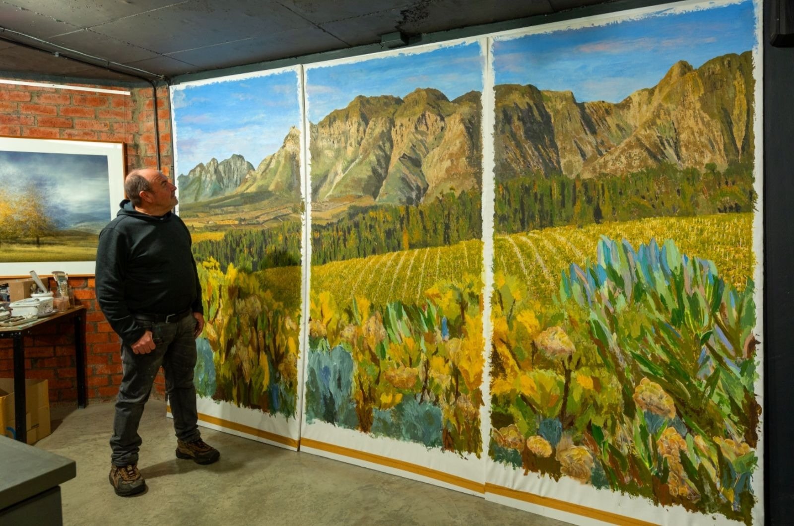 Martin Osner in his studio beside Heidelberg Harvest, a large commissioned triptych